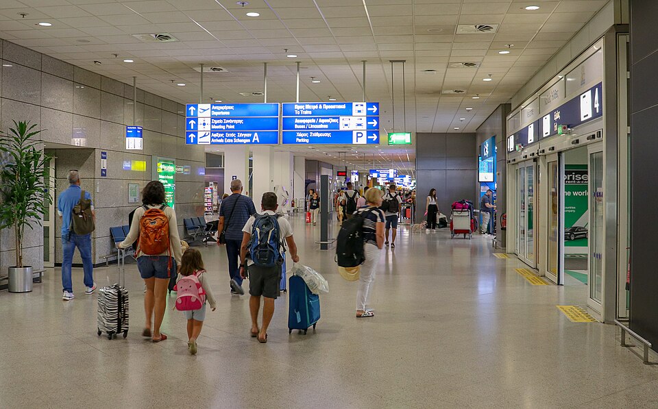 Travellers in the Athens airport terminal, photographed in 2019