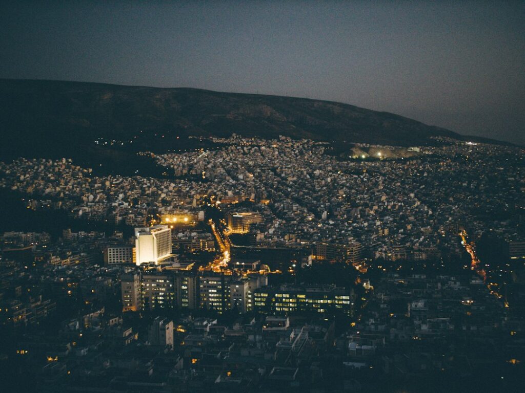 City buildings at night — illustrative photograph, not an airport meeting point