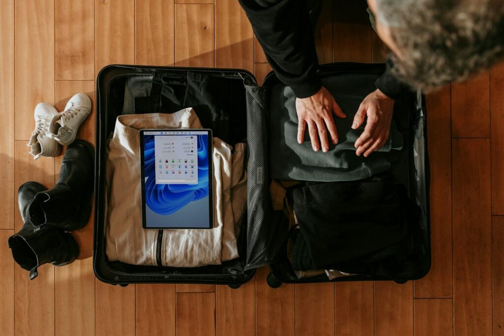 Packing a suitcase before a port-to-airport or city onward journey; illustrative stock photograph, not TransferHub fleet or an actual pickup point